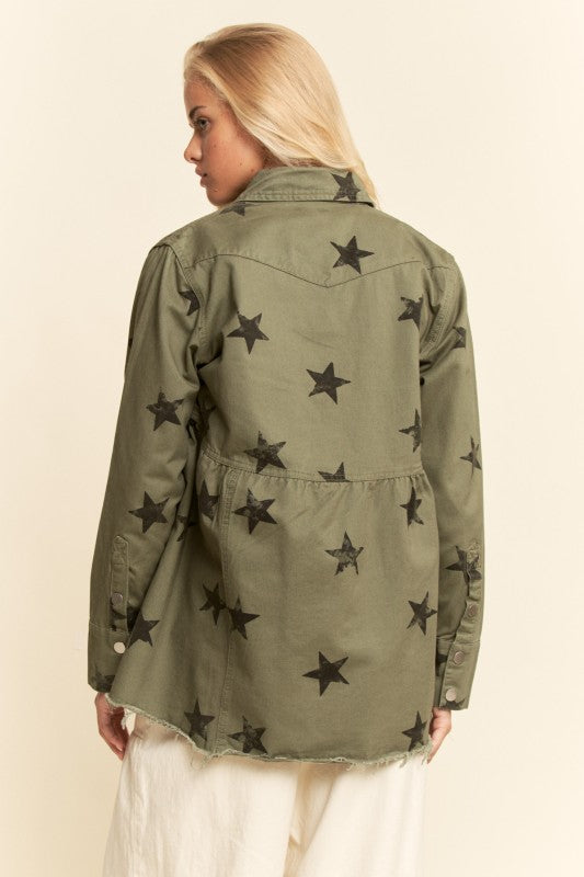 Woman wearing a green jacket with star patterns on a beige background