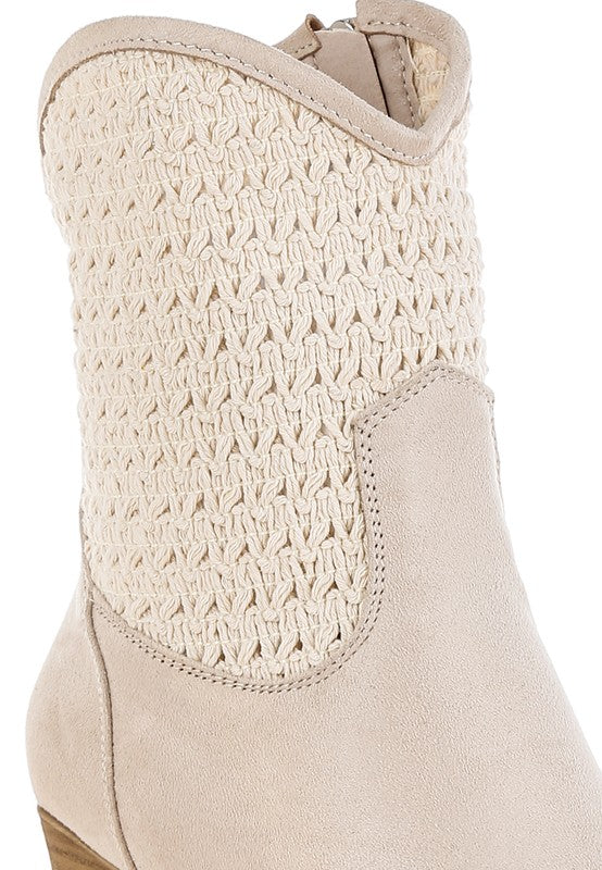 Close-up of a beige boot with textured toe area on a white background