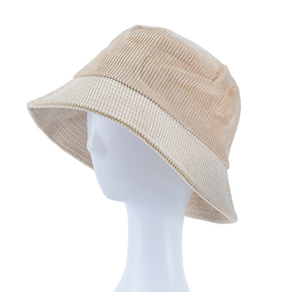 Beige bucket hat on a mannequin head against a white background