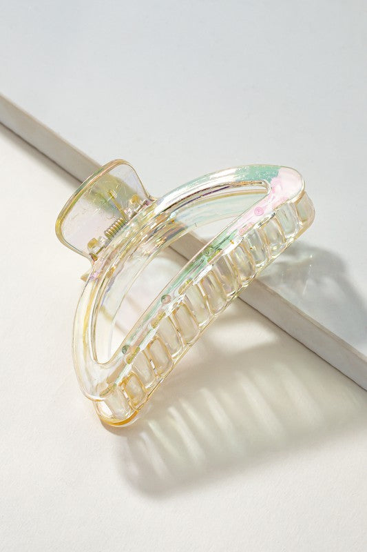 Iridescent hair clip on a light gray background