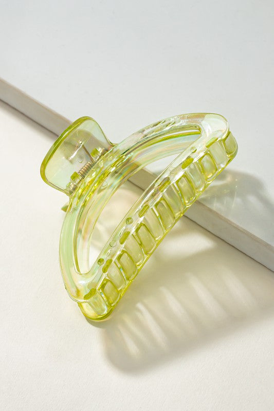 Clear yellow hair clip on a white background