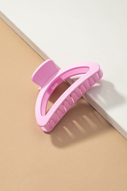Pink hair clip on a beige and white background