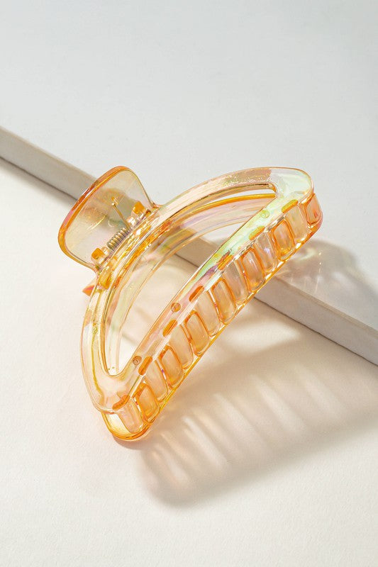 Orange hair clip on a light background