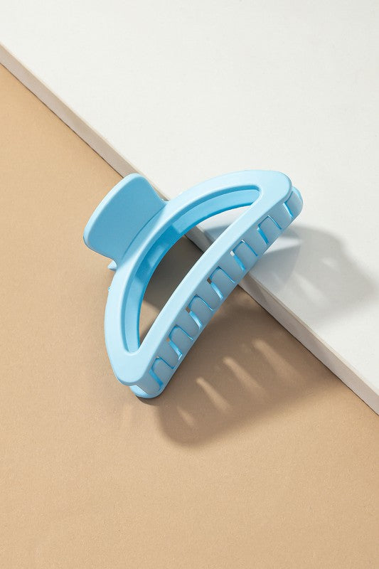 Blue hair clip on a beige and white background