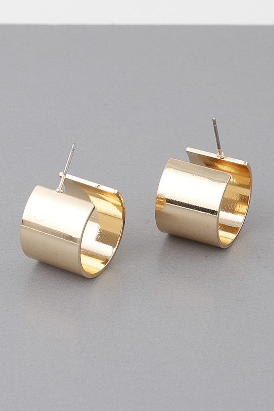 This image features a pair of elegant "Samantha Huggie Earrings." The earrings are designed as sleek, minimalistic hoops with a glossy gold finish, creating a sophisticated and modern look.