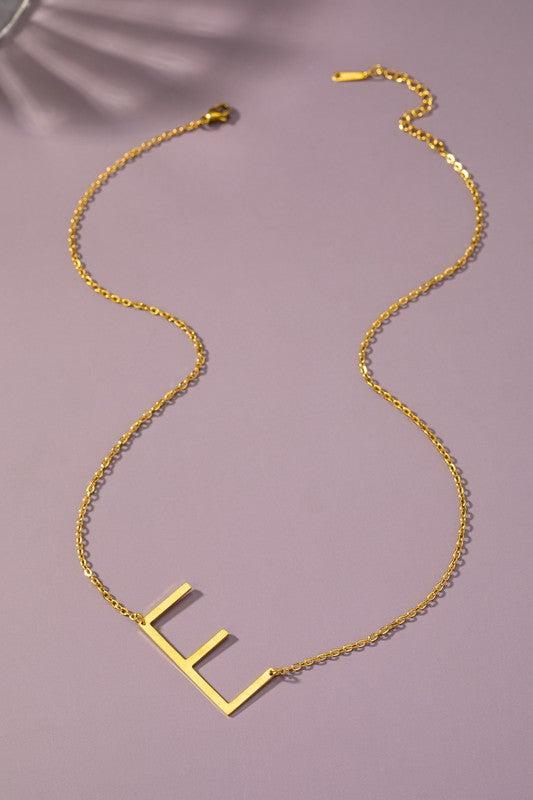 Gold necklace with a unique design on a purple background