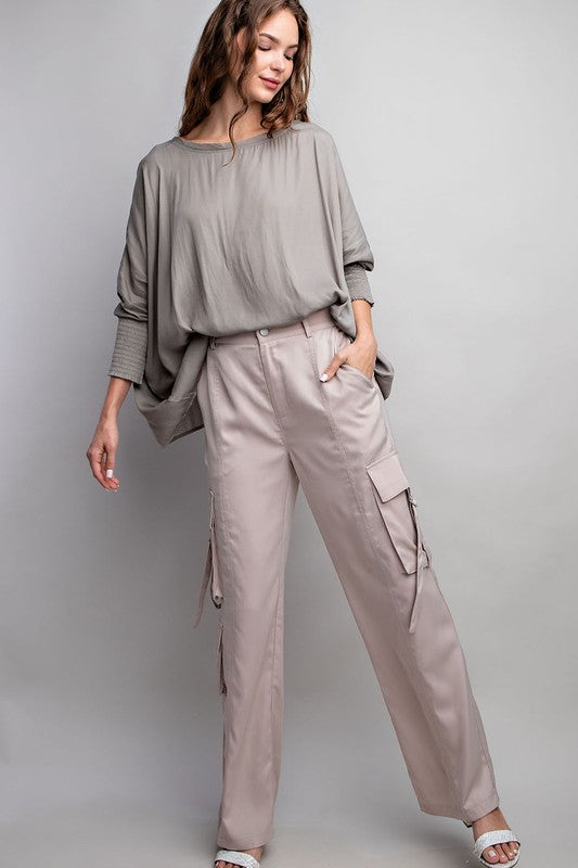 Woman wearing a gray outfit with a plain background