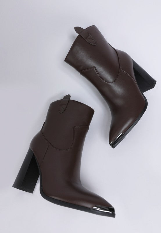 Pair of brown leather ankle boots on a light gray background