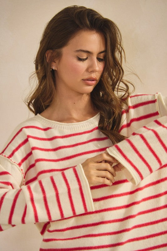 Woman wearing a red and white striped sweater against a neutral background