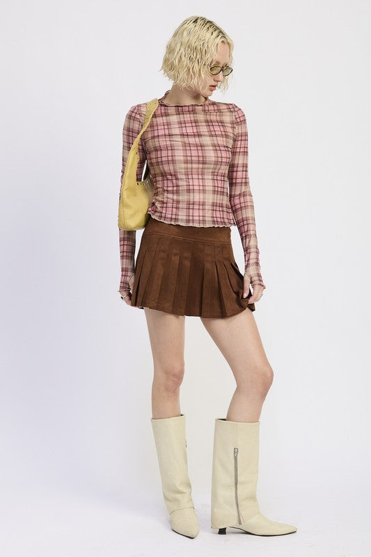 Woman wearing a plaid shirt and brown skirt with a yellow bag on a white background