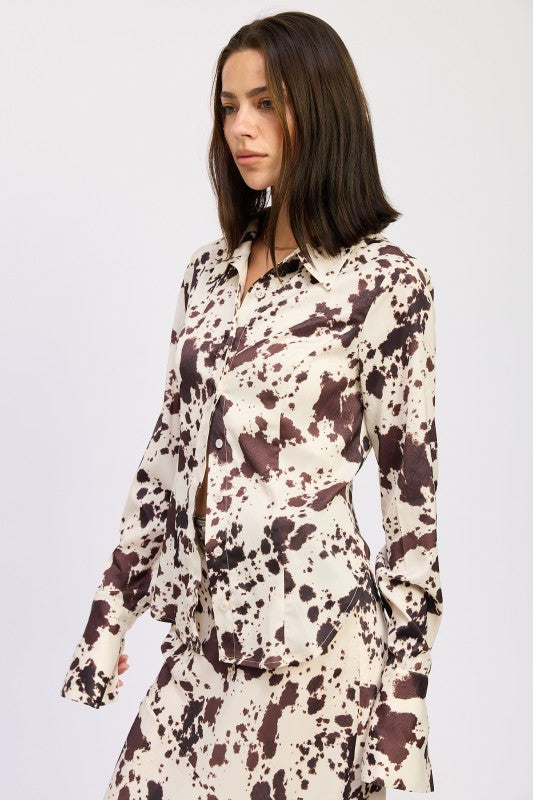 Woman wearing a long-sleeve floral dress against a white background