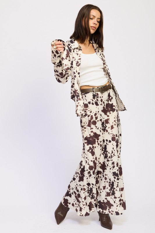 Woman wearing a patterned outfit with a white background