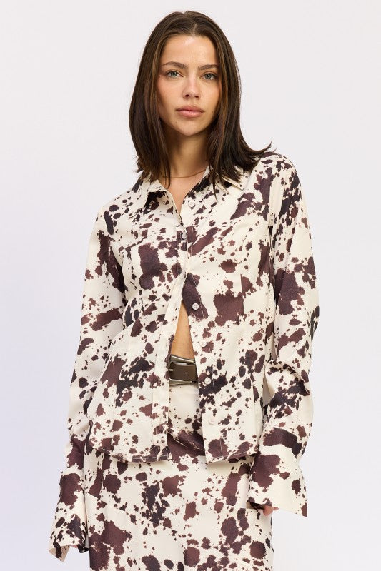 Woman wearing a patterned outfit on a plain background