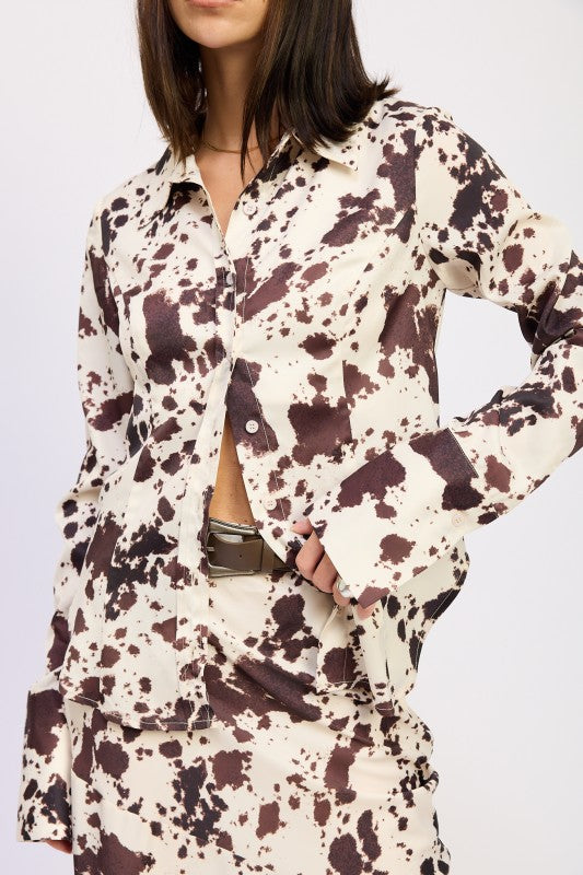 Person wearing a patterned outfit with long sleeves on a white background