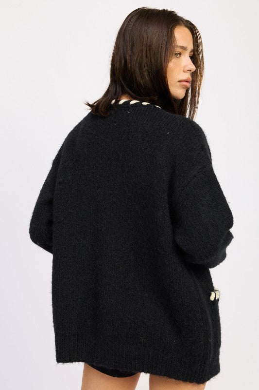 Woman wearing a black cardigan on a white background