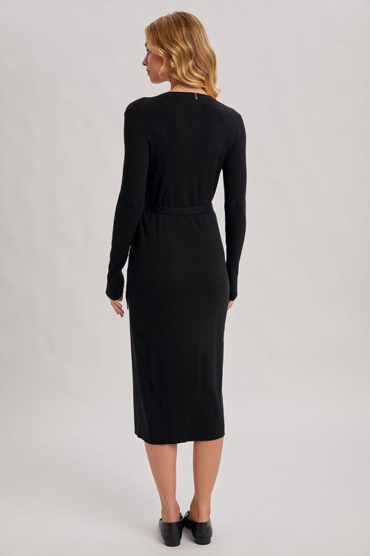 Woman wearing a black dress against a gray background