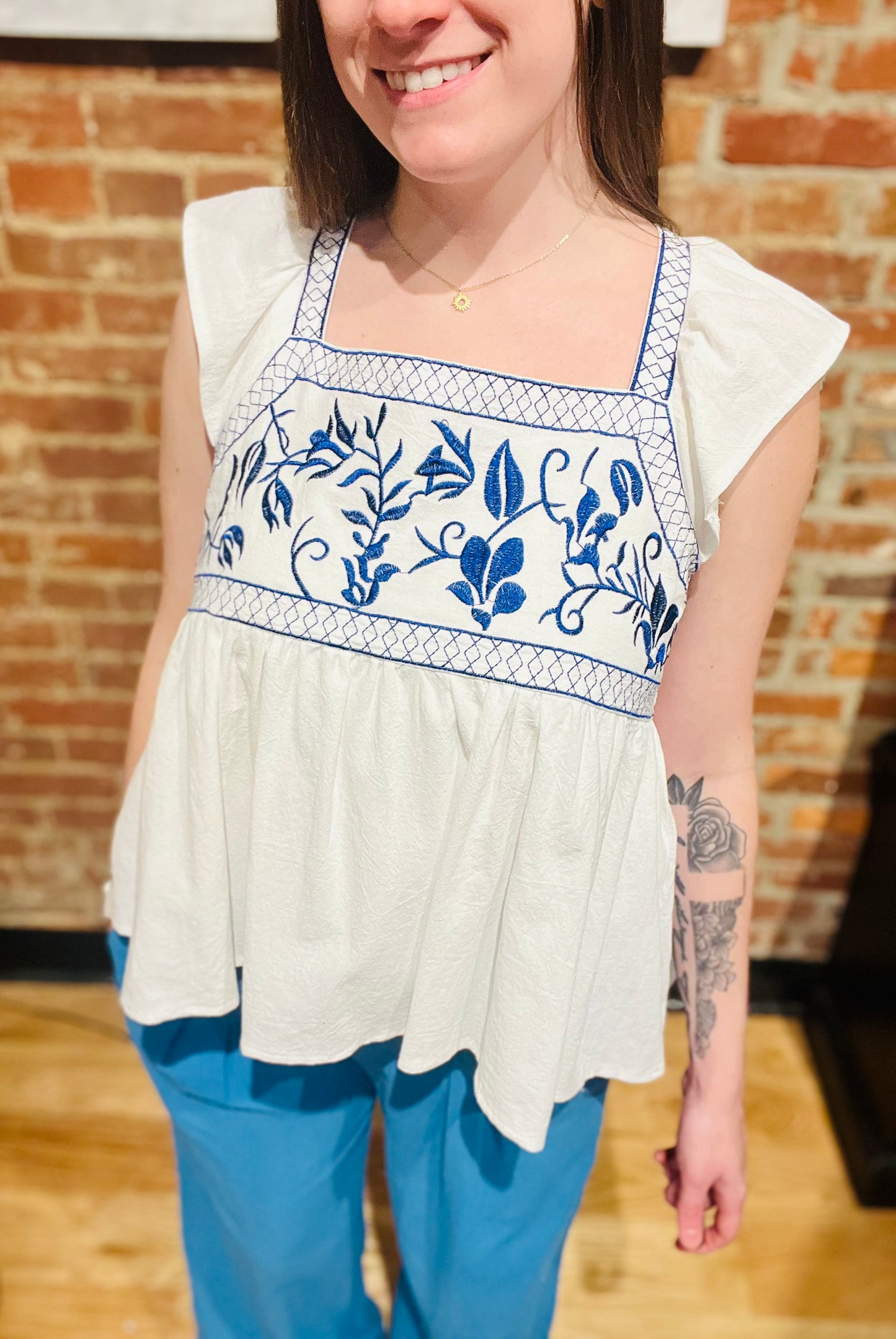 White Ruffle Sleeve Flowy Top with Blue Embroidered Detailing at Bust