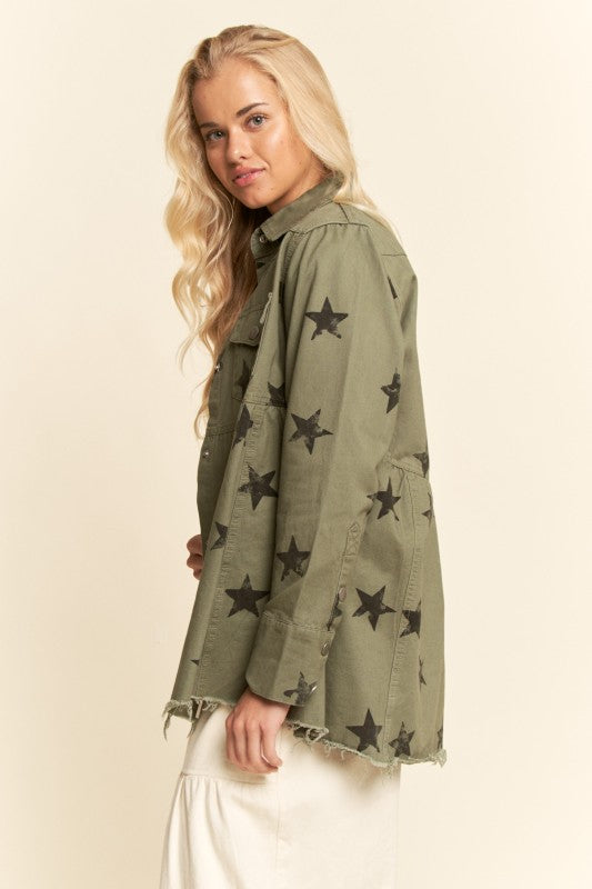 Woman wearing a green jacket with star patterns on a beige background