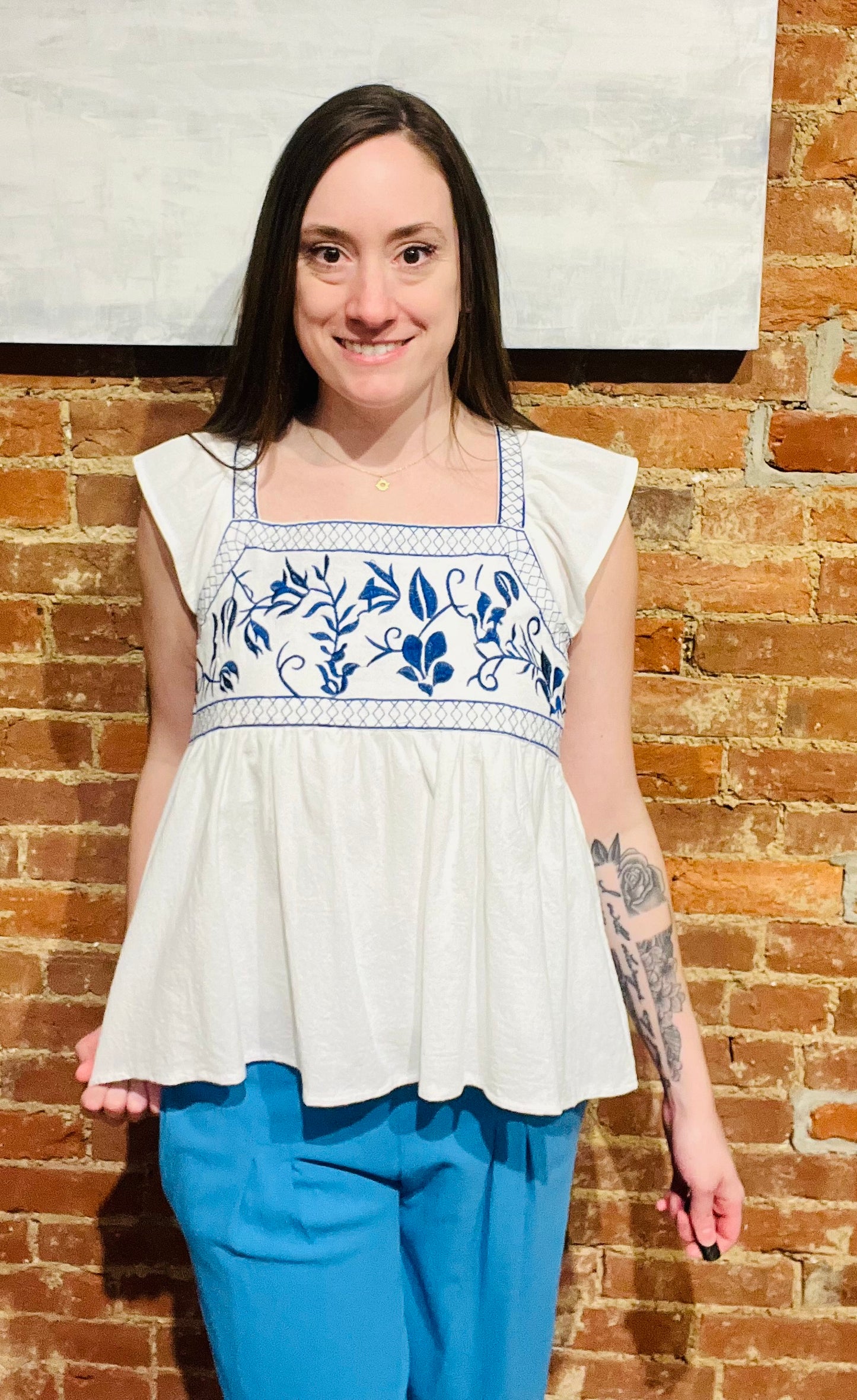 White Ruffle Sleeve Flowy Top with Blue Embroidered Detailing at Bust