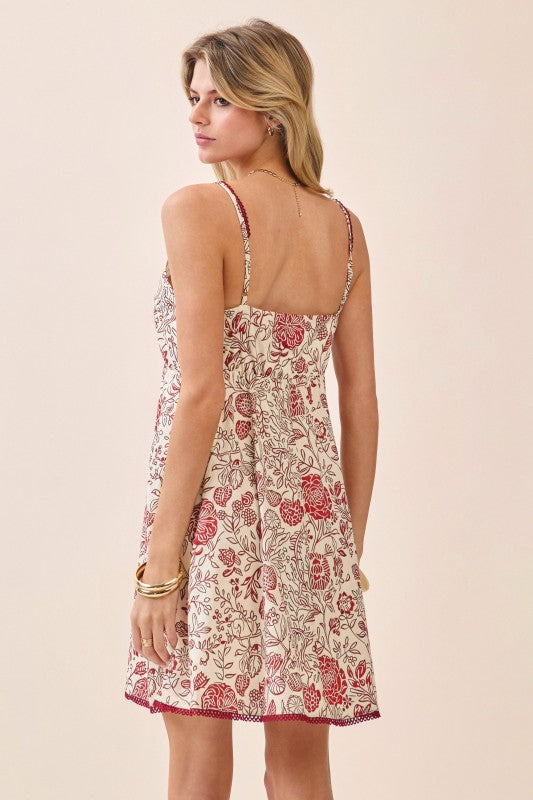 Woman wearing a floral dress with a beige background