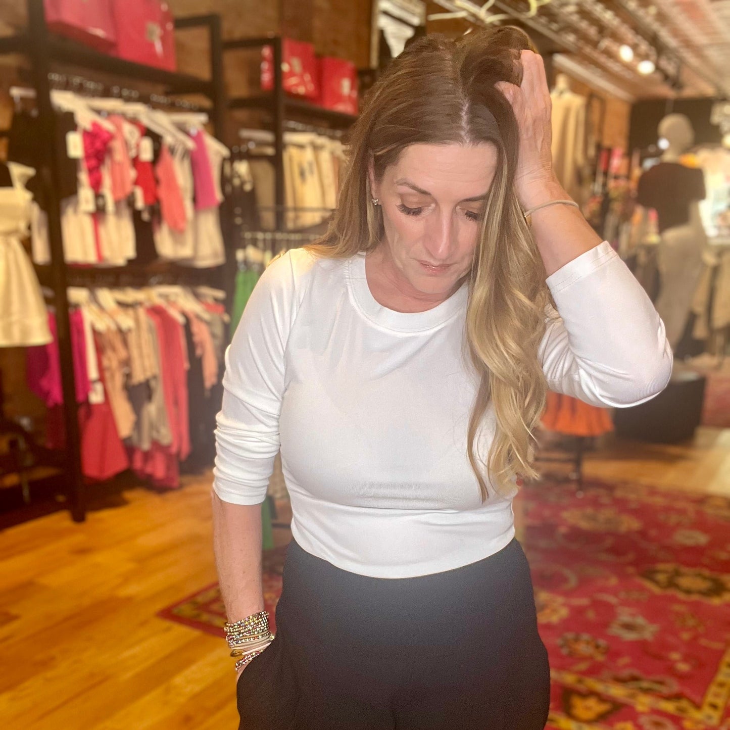 woman wearing a white long sleeve ribbed tee with black pants