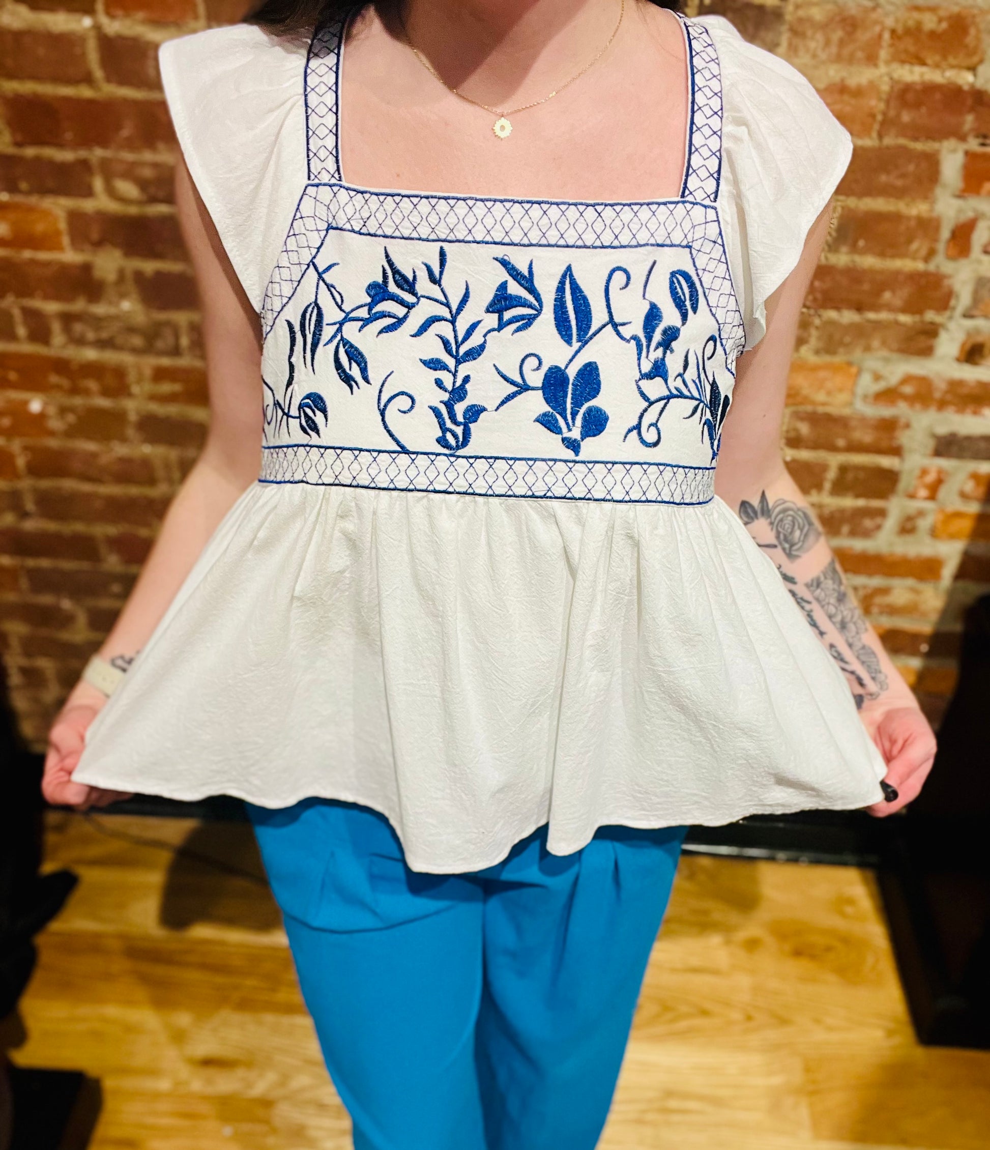 White Ruffle Sleeve Flowy Top with Blue Embroidered Detailing at Bust