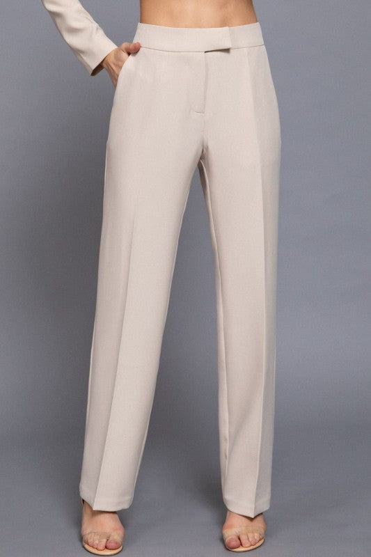 Beige pants worn by a person on a gray background