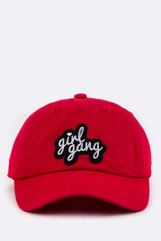 Red cap with 'girl gang' text on a white background
