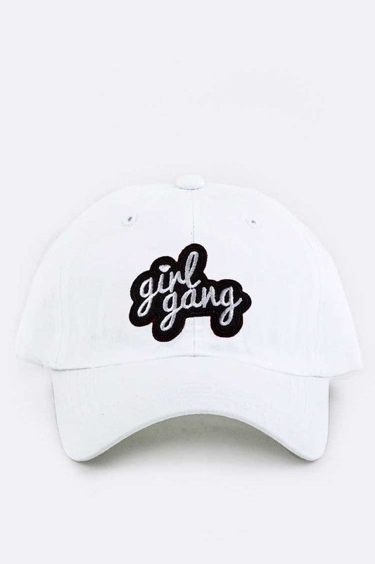 White cap with 'girl gang' text on a white background