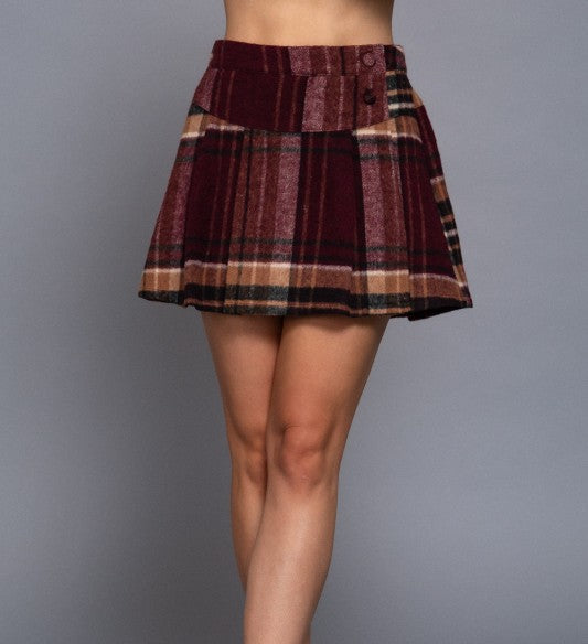 Plaid skirt worn by a person on a gray background