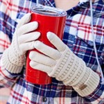 Person holding a red cup with a plaid shirt and textured gloves