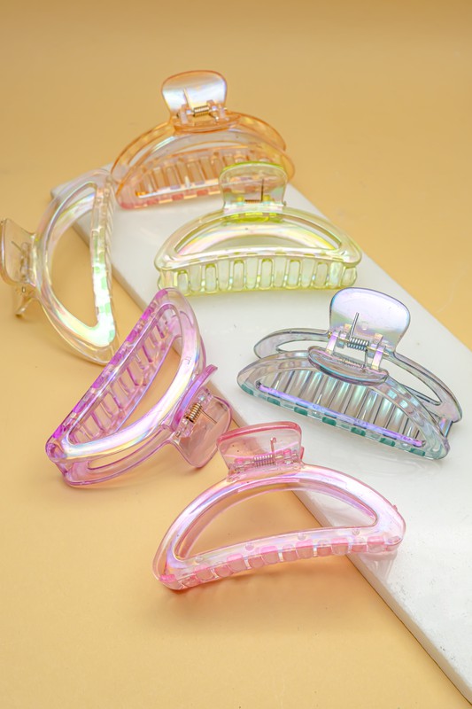 Set of colorful transparent hair clips on a beige background