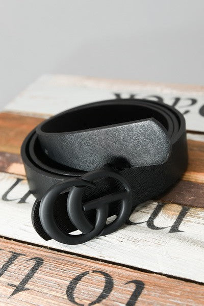 Black belt with a unique buckle on a wooden surface