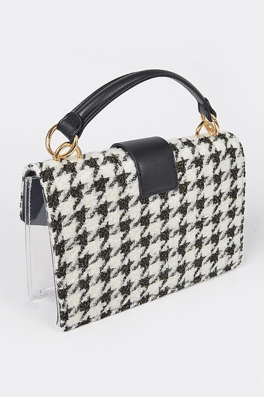 Houndstooth patterned handbag with black accents on a white background