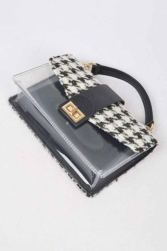 Handbag with houndstooth pattern and clear front panel on a light gray background