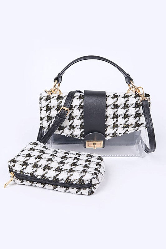 Black and white houndstooth patterned handbag with matching pouch on a light gray background