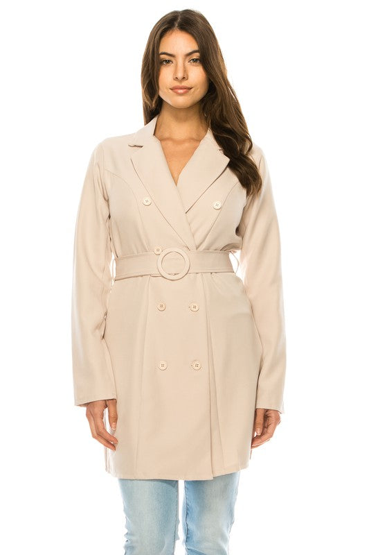 Woman wearing a beige trench coat on a white background