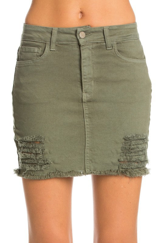 Green denim skirt with frayed hem on a white background