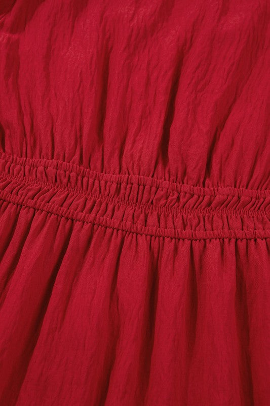 Close up of a red dress with a sinched waist