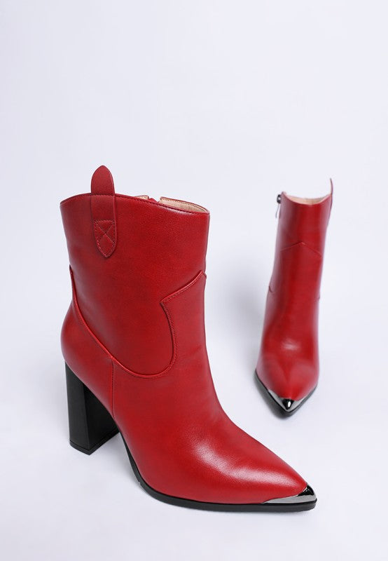 Red leather boots with a pointed toe and block heel on a white background