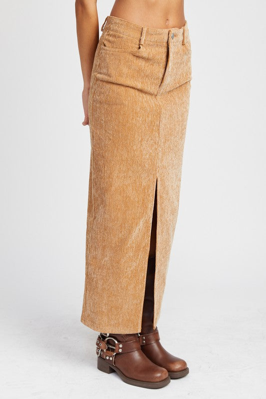 Tan corduroy pants with a front slit worn by a person on a white background