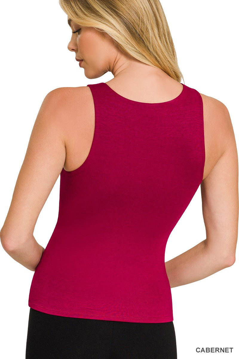 Woman wearing a cabernet tank top on a white background