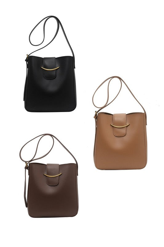 Three bags in black, brown, and another brown shade on a white background