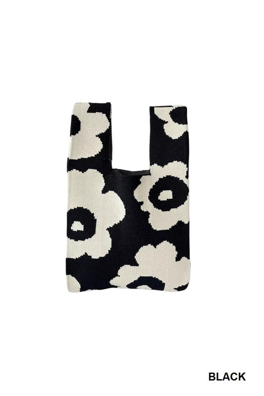 Black reusable shopping bag with white floral pattern on a white background