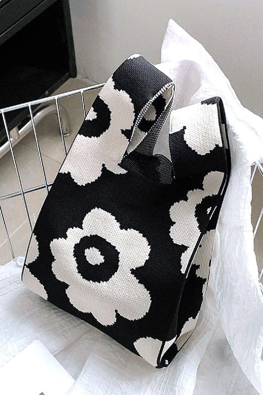 Black and white patterned fabric with a floral design on a plain background