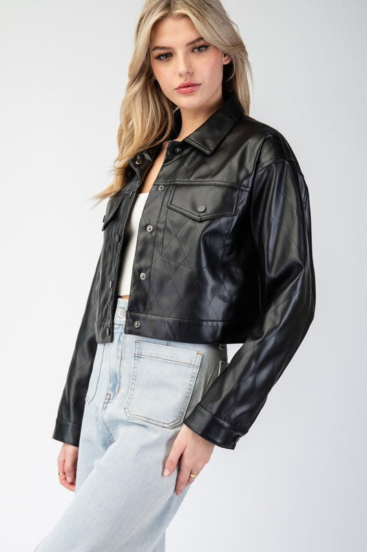 Woman wearing a black leather jacket and light blue jeans on a white background