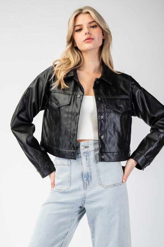 Woman wearing a black leather jacket and light blue jeans on a white background