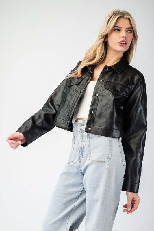 Woman wearing a black leather jacket and light blue jeans on a white background