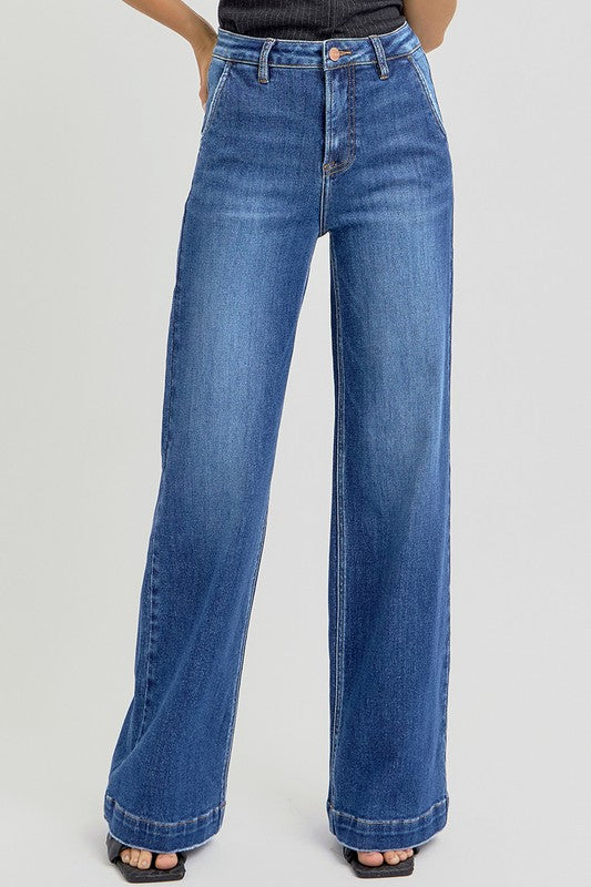 Blue jeans worn by a person on a light gray background
