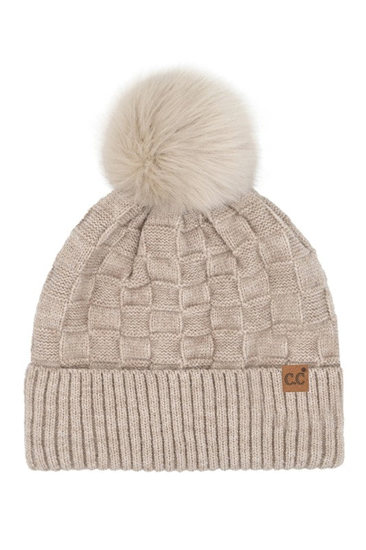 Beige knit beanie with pom-pom on a white background